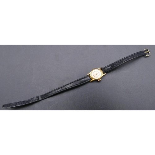 738 - An 18ct gold ladies' MuDu wristwatch with leather strap bracelet (working)