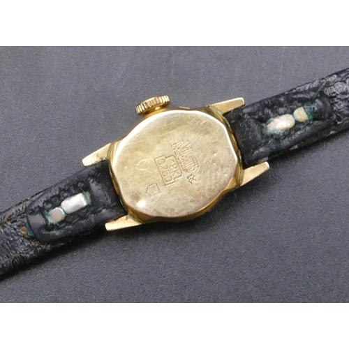 738 - An 18ct gold ladies' MuDu wristwatch with leather strap bracelet (working)