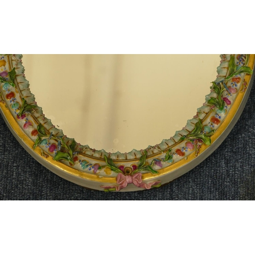 74 - A Meissen oval hanging and freestanding dressing table mirror with 2 raised Cupids with allover encr... 