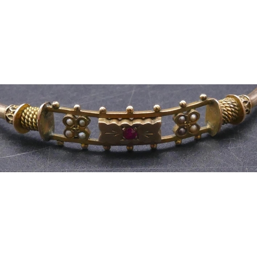 756 - A 9ct gold bangle set with centre red stone and half pearls (clasp in need of restoration), 7.5 gram... 