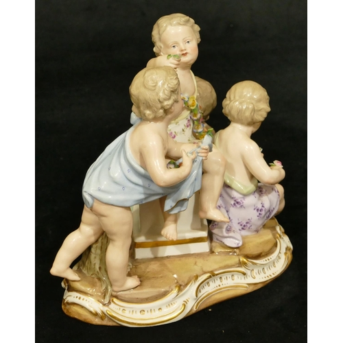 76 - A Meissen group of 4 seated children (1 right foot, 1 part left foot missing, chip to encrusted bask... 