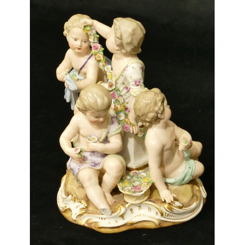 76 - A Meissen group of 4 seated children (1 right foot, 1 part left foot missing, chip to encrusted bask... 