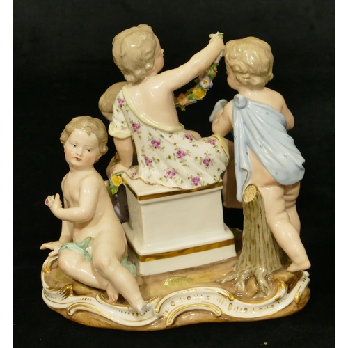 76 - A Meissen group of 4 seated children (1 right foot, 1 part left foot missing, chip to encrusted bask... 