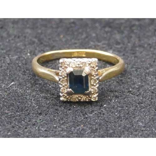 760 - An 18ct gold ladies' rectangular shaped ring set with centre sapphire surrounded by small diamond ch... 