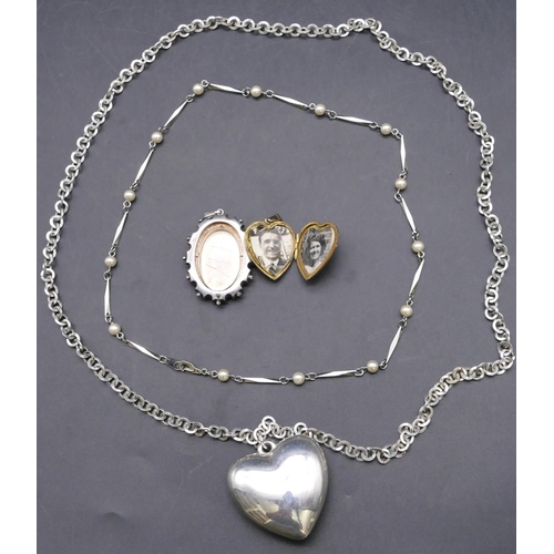 764 - A silver oval drop pendant, a 9ct gold front and back heart shaped locket with hinged front and a la... 