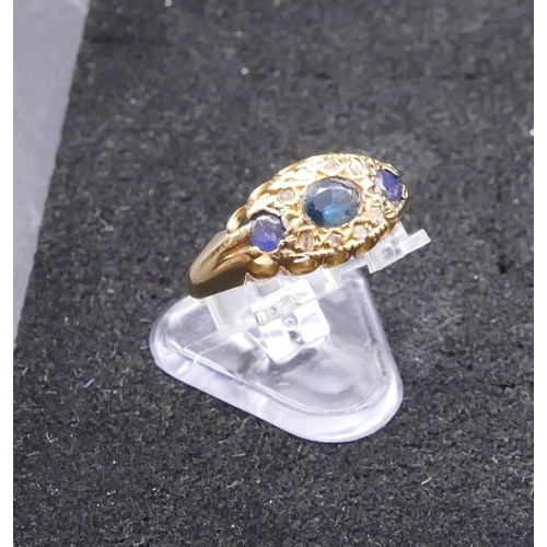 770 - An 18ct gold ladies' ring set with 3 sapphires interspersed by 8 small  diamonds, size N/O, 2.1 gram... 