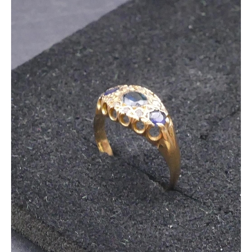 770 - An 18ct gold ladies' ring set with 3 sapphires interspersed by 8 small  diamonds, size N/O, 2.1 gram... 