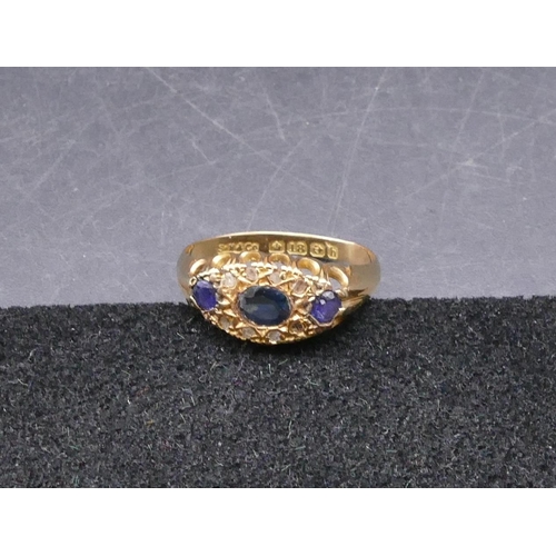 770 - An 18ct gold ladies' ring set with 3 sapphires interspersed by 8 small  diamonds, size N/O, 2.1 gram... 