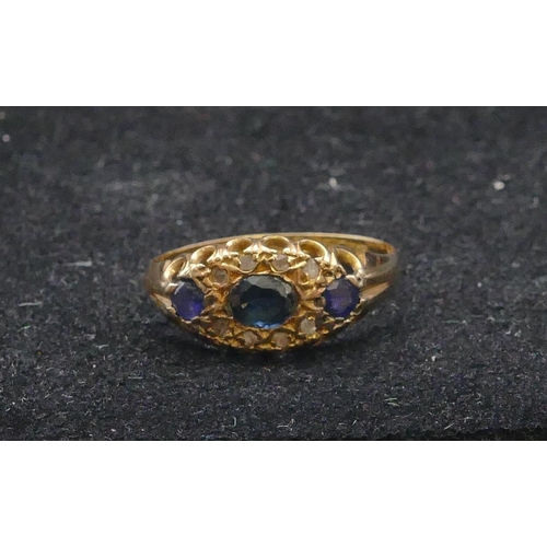 770 - An 18ct gold ladies' ring set with 3 sapphires interspersed by 8 small  diamonds, size N/O, 2.1 gram... 