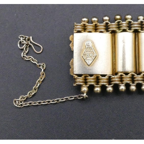 774 - A Victorian silver gilt coloured metal panelled bracelet with engraved decoration in fitted Spink & ... 