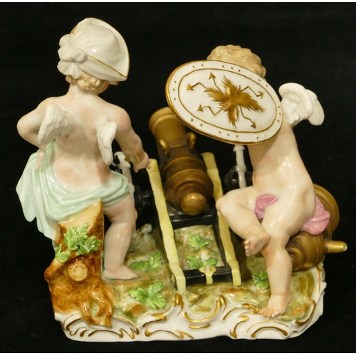 78 - A Meissen group of 2 Cupids standing either side of a canon, (touch light stick missing end and plum... 