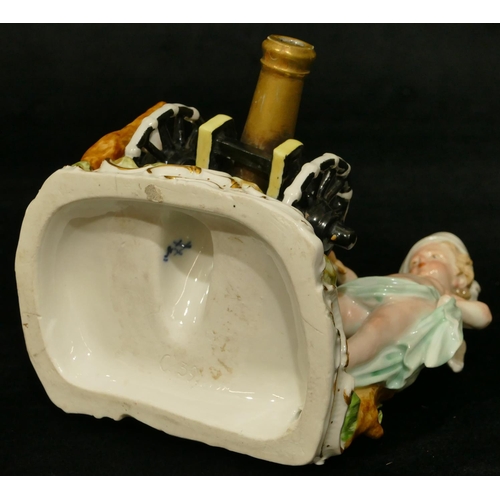 78 - A Meissen group of 2 Cupids standing either side of a canon, (touch light stick missing end and plum... 