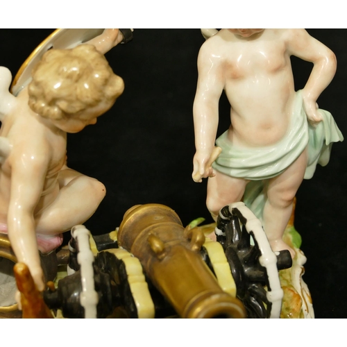 78 - A Meissen group of 2 Cupids standing either side of a canon, (touch light stick missing end and plum... 