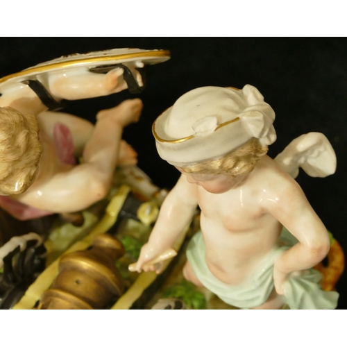 78 - A Meissen group of 2 Cupids standing either side of a canon, (touch light stick missing end and plum... 