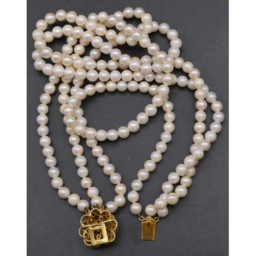 780 - A cultured pearl triple choker necklace with a high carat gold scallop shaped clasp with waterfall d... 