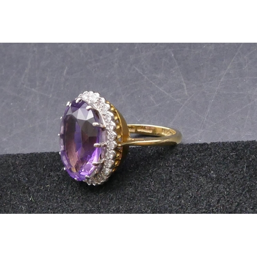 781 - An 18ct gold large ladies' oval cluster ring set with centre amethysts surrounded by 28 diamonds, si... 