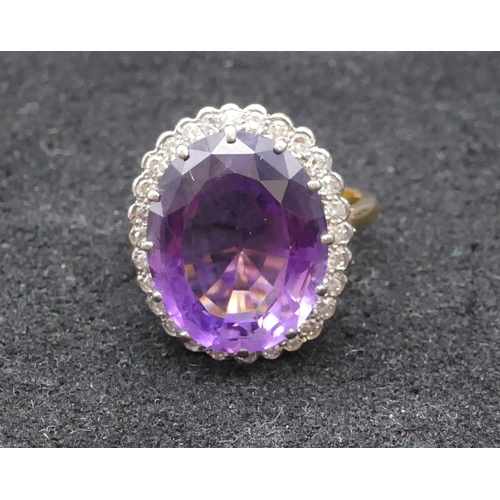 781 - An 18ct gold large ladies' oval cluster ring set with centre amethysts surrounded by 28 diamonds, si... 