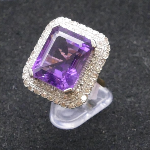 783 - An 18ct gold rectangular shaped ladies' large cluster ring set with centre amethyst surrounded by 2 ... 