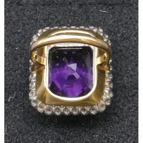 783 - An 18ct gold rectangular shaped ladies' large cluster ring set with centre amethyst surrounded by 2 ... 