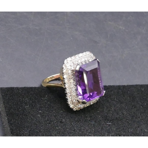 783 - An 18ct gold rectangular shaped ladies' large cluster ring set with centre amethyst surrounded by 2 ... 