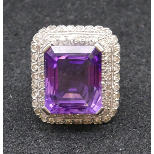 783 - An 18ct gold rectangular shaped ladies' large cluster ring set with centre amethyst surrounded by 2 ... 