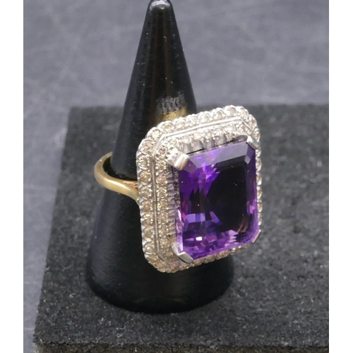 783 - An 18ct gold rectangular shaped ladies' large cluster ring set with centre amethyst surrounded by 2 ... 