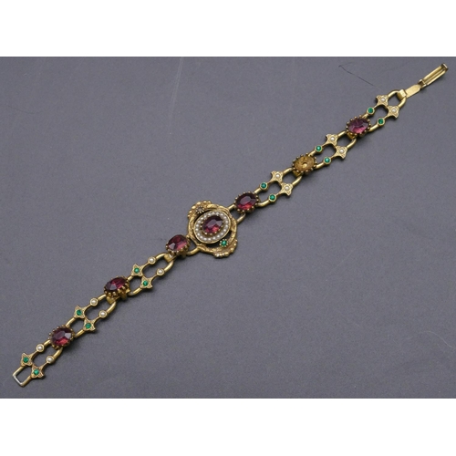 793 - A gilt paste bracelet with various coloured stones (1 missing)