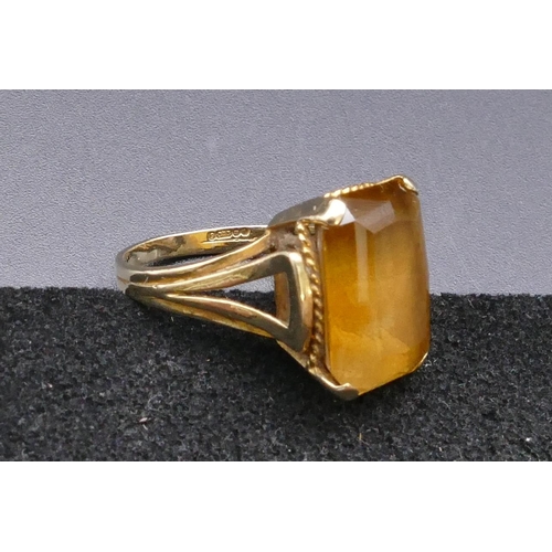 803 - A 9ct gold rectangular shaped ring set with yellow coloured stone, size L, 5.4 grams