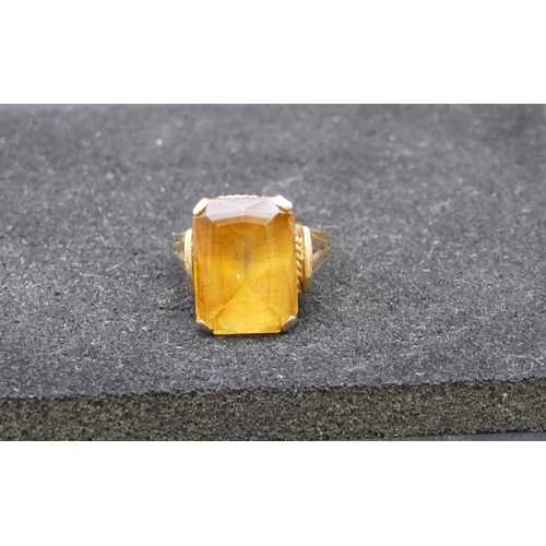 803 - A 9ct gold rectangular shaped ring set with yellow coloured stone, size L, 5.4 grams