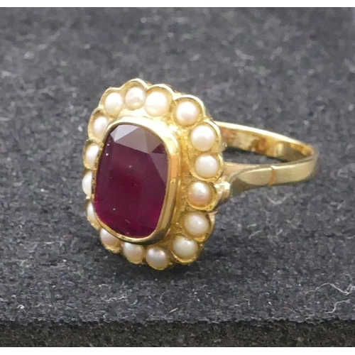 805 - An 18ct gold ladies' ring set with centre red stone surrounded by half pearls, size M/N, 6 grams gro... 