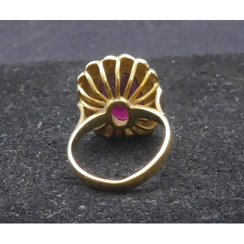 805 - An 18ct gold ladies' ring set with centre red stone surrounded by half pearls, size M/N, 6 grams gro... 