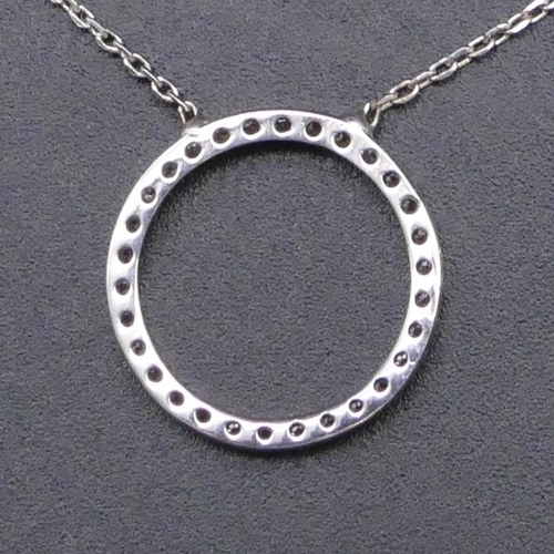 812 - A 925 silver pendant in form of a circle and mounted with clear stones, with chain.