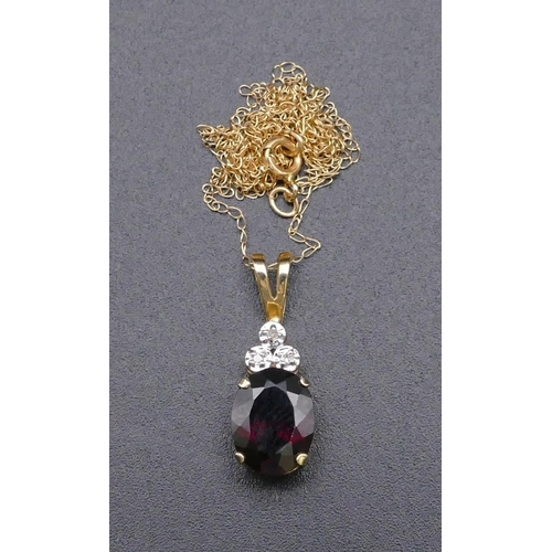 814 - A 9ct gold drop pendant set with garnet and 3 small diamonds, with chain, 1.4 grams gross.