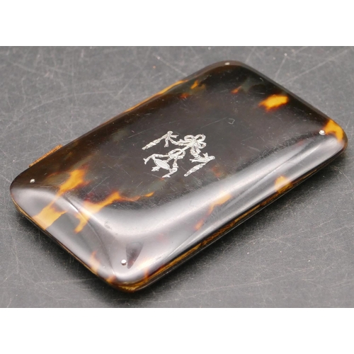 838 - A tortoiseshell double-opening needle case with inlaid silver motif, 8cm long