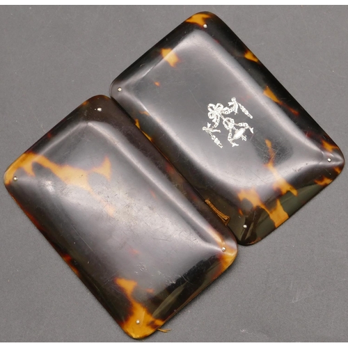 838 - A tortoiseshell double-opening needle case with inlaid silver motif, 8cm long