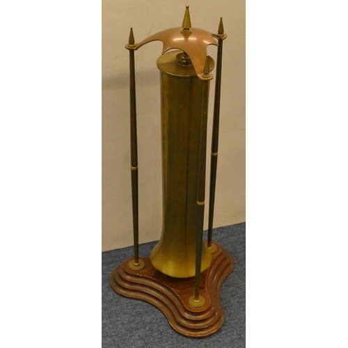 842 - An early 20th Century brass and copper floor gong (old gun shell) on mahogany tripod base, 70cm high