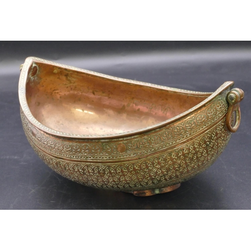 980 - An Eastern copper oval boat shaped 2-handled bowl with allover raised decoration 23.5cm wide