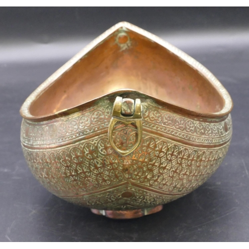 980 - An Eastern copper oval boat shaped 2-handled bowl with allover raised decoration 23.5cm wide