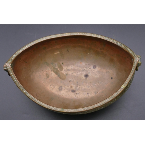 980 - An Eastern copper oval boat shaped 2-handled bowl with allover raised decoration 23.5cm wide