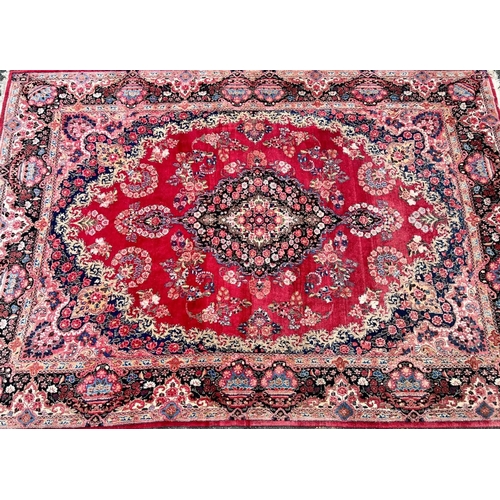 981 - A Persian carpet on red and blue ground having centre medallion 397 x 270cm