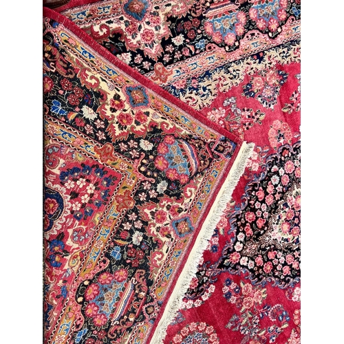 981 - A Persian carpet on red and blue ground having centre medallion 397 x 270cm