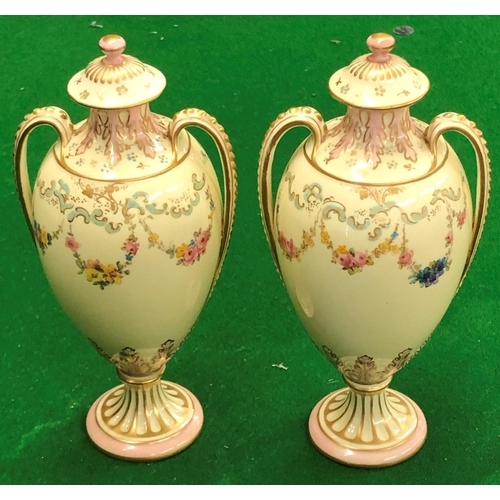 194 - A Pair Royal Crown Derby round bulbous thin necked 2 handled lidded vases on cream ground with flora... 