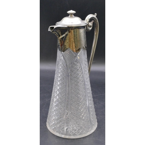 440 - A cut glass round decanter with silver plated neck, hinged lid and scroll handle, allover tooth cut ... 