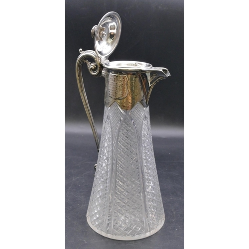 440 - A cut glass round decanter with silver plated neck, hinged lid and scroll handle, allover tooth cut ... 