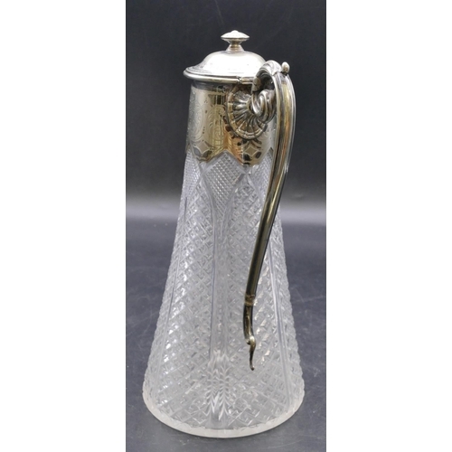 440 - A cut glass round decanter with silver plated neck, hinged lid and scroll handle, allover tooth cut ... 