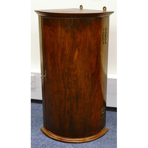 1153 - A small hanging bow fronted corner cupboard, 63.5cm high, 37.5cm wide, 30cm deep