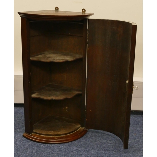 1153 - A small hanging bow fronted corner cupboard, 63.5cm high, 37.5cm wide, 30cm deep