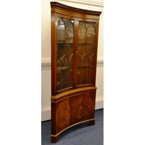 1158 - A good quality reproduction mahogany concaved free standing corner cupboard with key pattern cornice... 