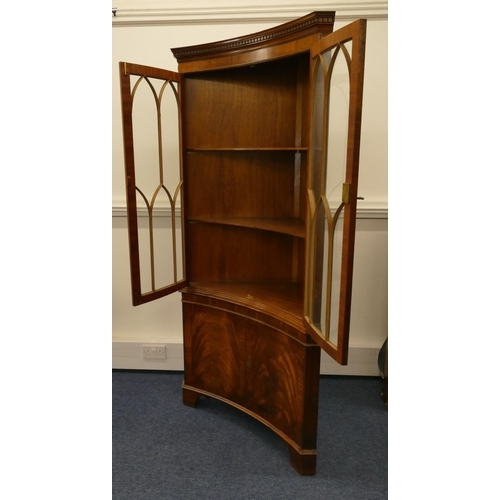 1158 - A good quality reproduction mahogany concaved free standing corner cupboard with key pattern cornice... 