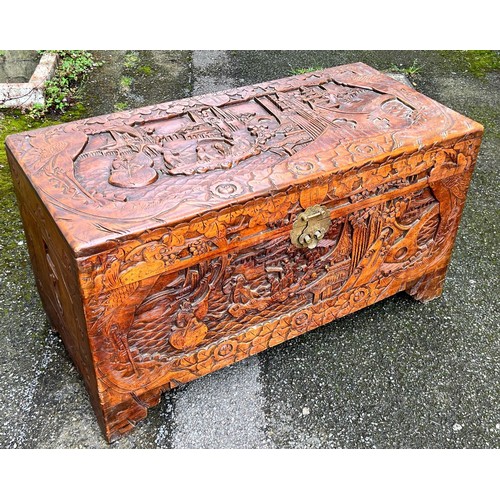 6145 - A camphor wood trunk with hinged lid and allover carved figure, landscape and floral decoration, 95 ... 